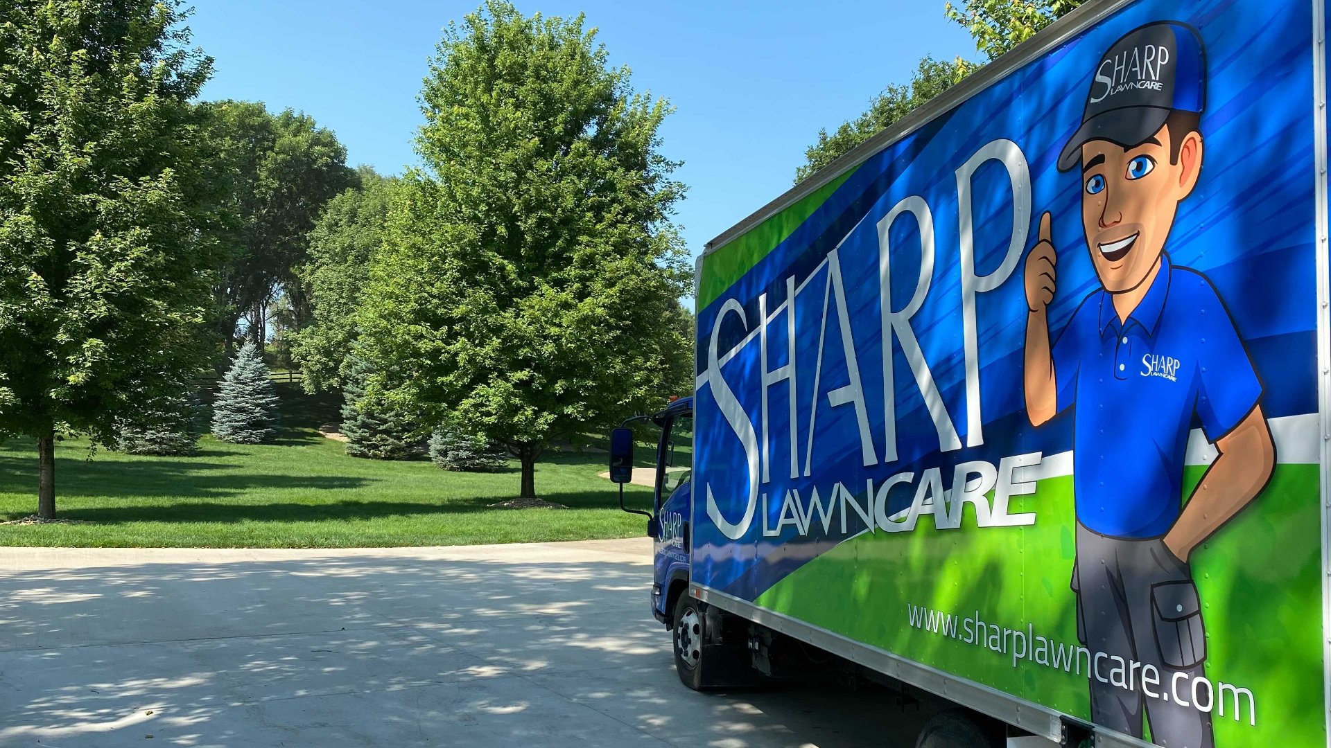 Sharp Lawn Care work truck at a property in Sioux Falls, SD.