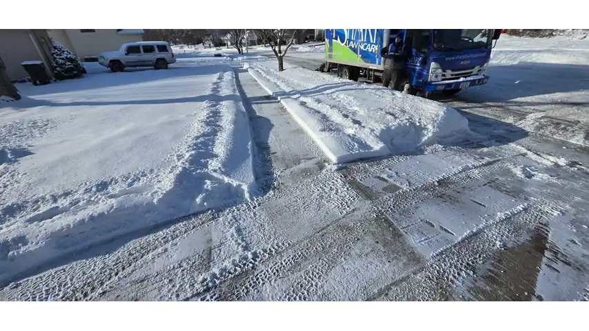 Sidewalk being cleared after snowfall in Sioux City, IA.