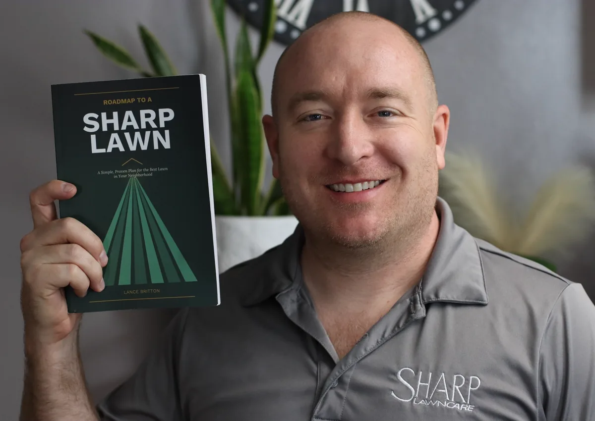 Lance Britton holding Roadmap to a Sharp Lawn