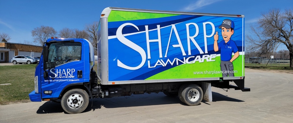 Sharp lawn care company truck displayed near Akron, IA.