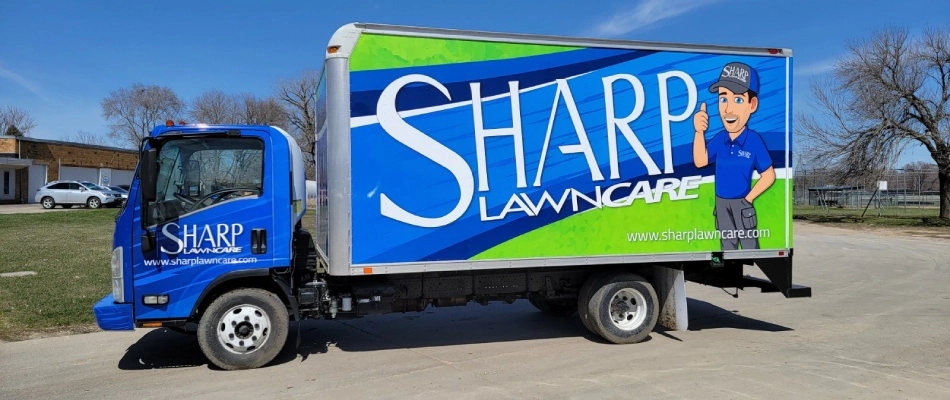 Sharp lawn care company truck displayed near Akron, IA.