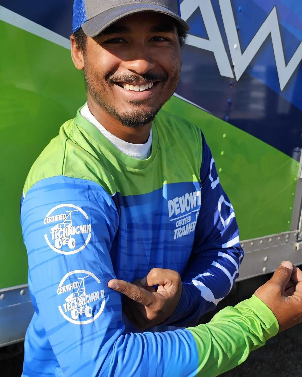 Sharp Lawn Care technician in branded uniform