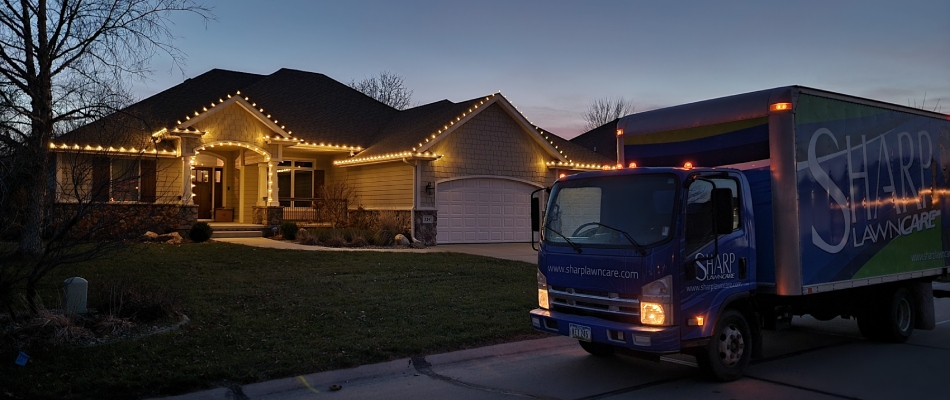 Sharp truck displayed in front of home with holiday lighting installed in South Sioux City, NE.