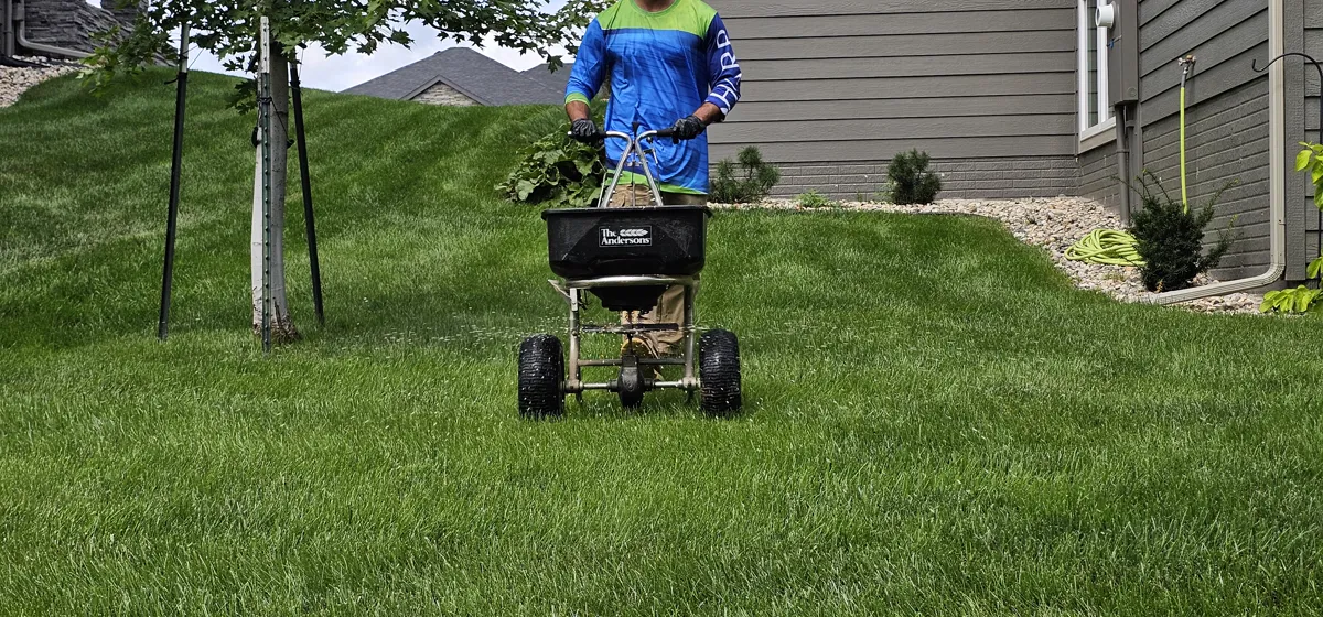 Close-up of a professional spreader in operation on a Sergeant Bluff IA lawn