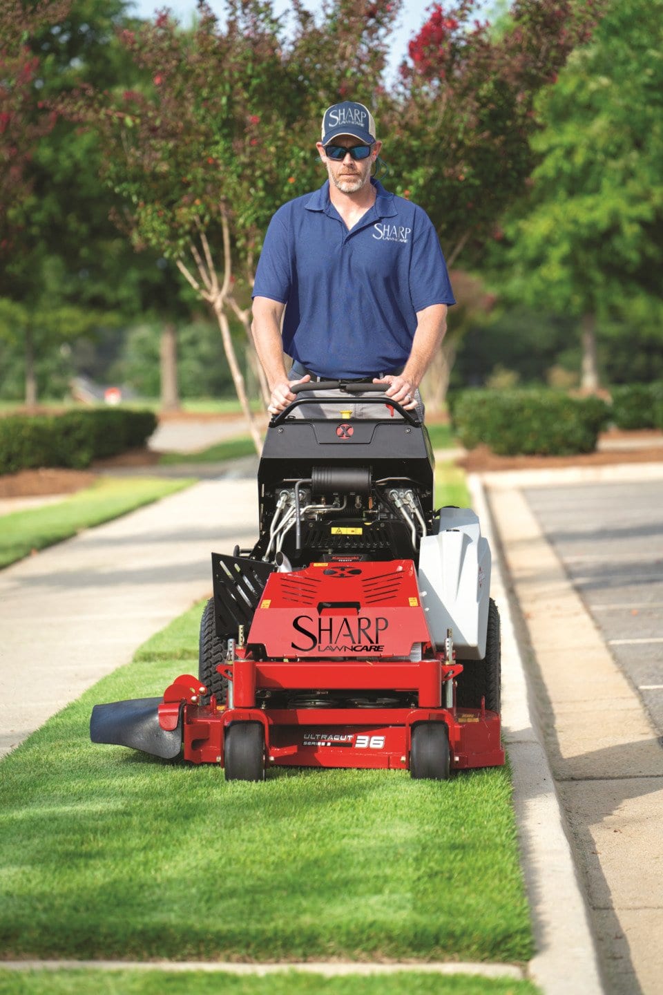 Sharp Lawn Care employee mowing a lawn in Sioux Falls, SD.
