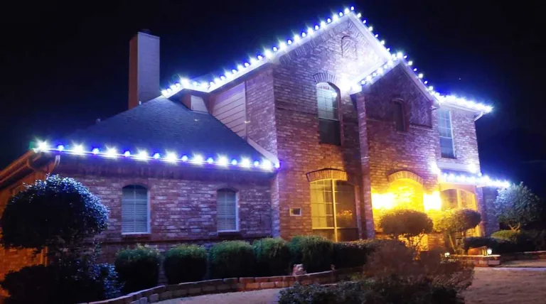 Christmas lights following every roofline and gable of a two story brick home in Sioux Falls at night