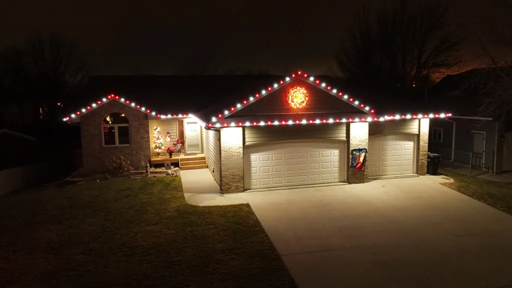 A Sioux Falls home square on at night with an alternating Christmas light pattern along every edge